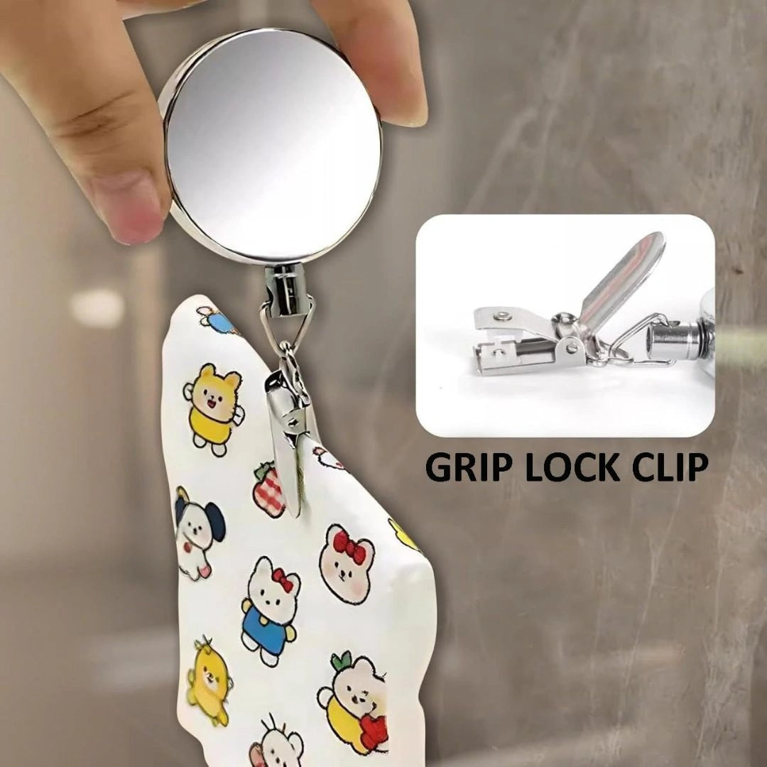 Kitchen towel held by retractable clip near sink